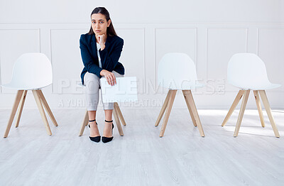 Buy stock photo Portrait business woman waiting for an interview or stress applicant sitting alone. Sad or nervous corporate professional holding resume in line for job opening, vacancy and opportunity in office