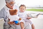 Story, book and baby with grandmother and teddy bear for child development, learning and growth with happy smile portrait. Grandma reading to kid on the patio at their family home for love and care