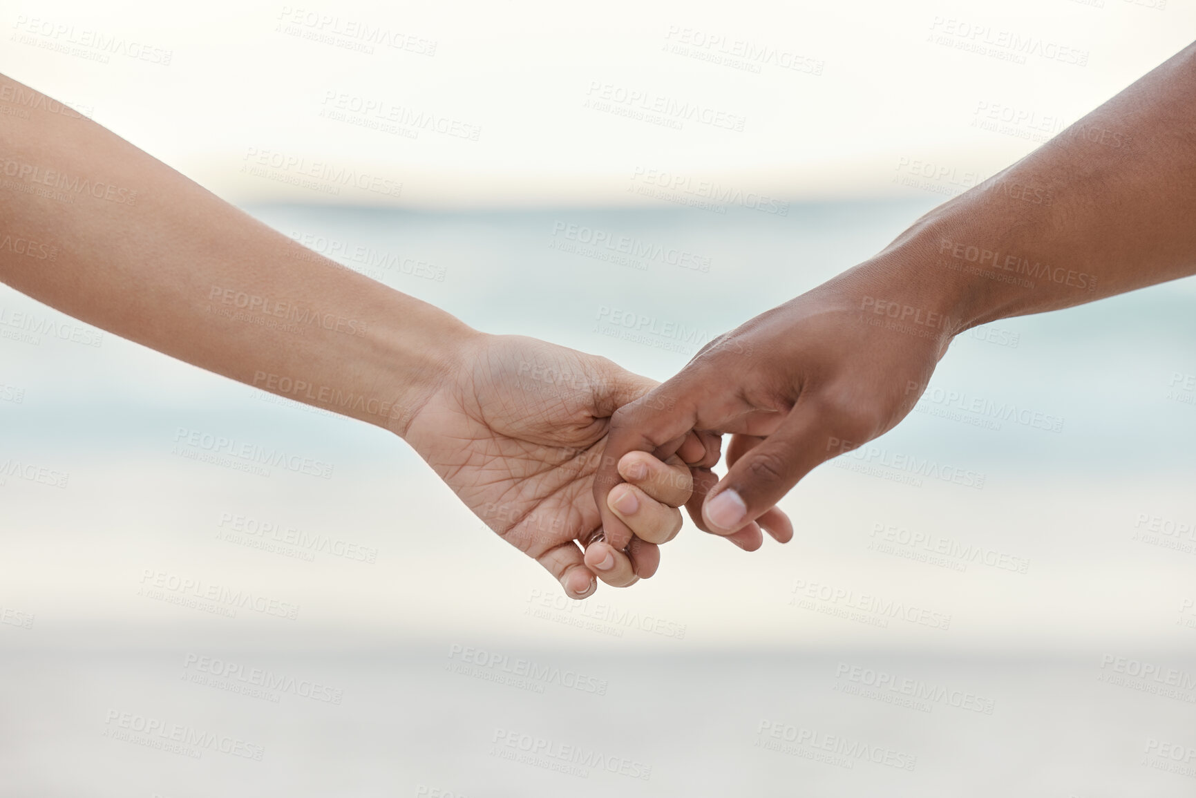 Buy stock photo Touch, love and support with interracial couple holding hands in a committed, loving and close relationship. Closeup hands of man and woman enjoying beach travel, sea vacation or holiday and romance