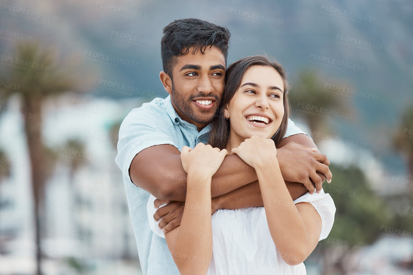 Buy stock photo Couple, love and smile while hugging and enjoying their vacation, holiday and free time together while sharing a laugh, joy and commitment. Happy man and woman enjoying view and healthy relationship