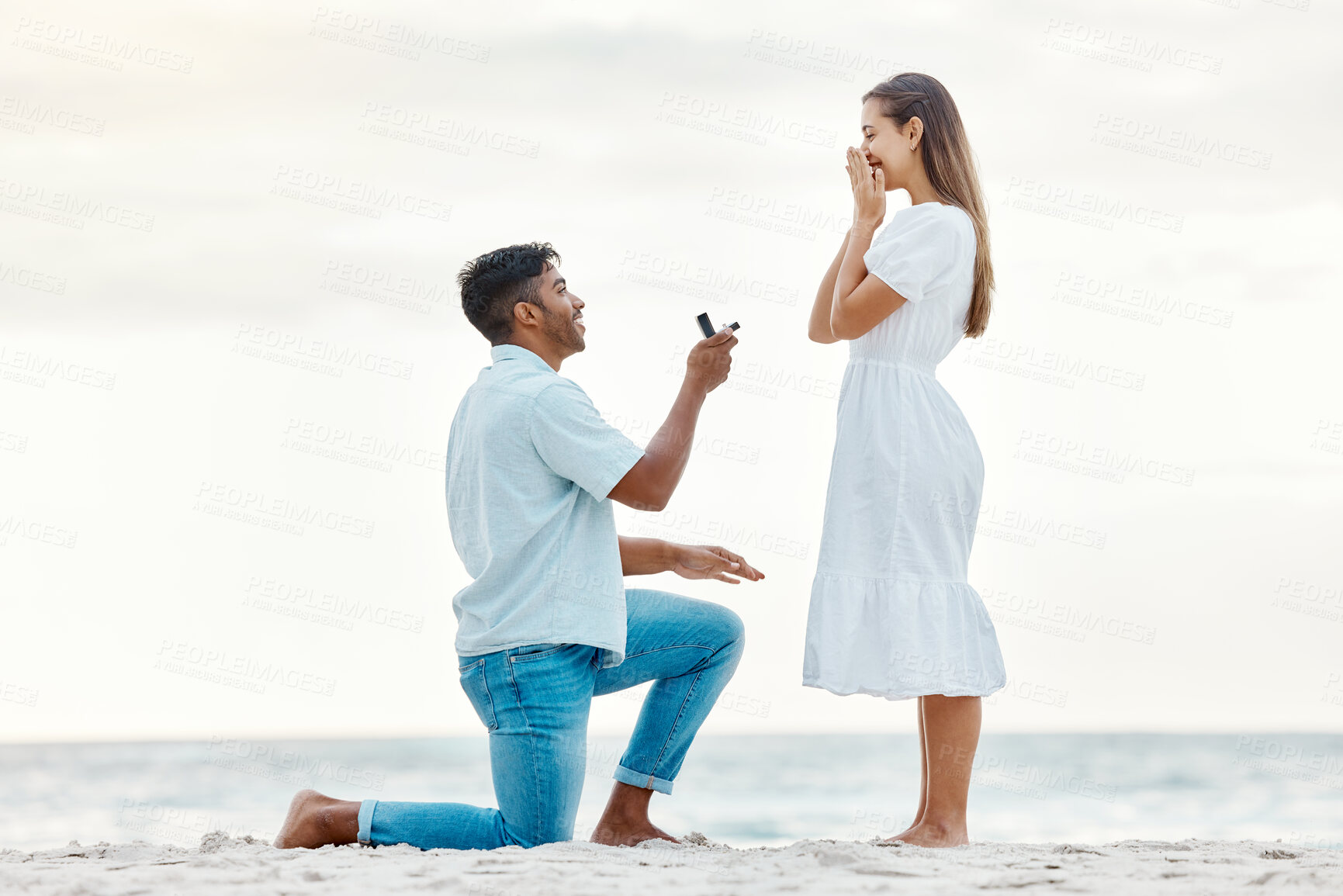 Buy stock photo Engagement, beach and a couple with a marriage proposal with a ring while on romantic vacation. Love, romance and happy couple getting engaged while on a summer holiday in nature by the ocean.