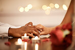 Couple holding hands at valentines table on date or romantic anniversary celebration together. Man touch black woman fingers, as expression of love at dinner with candles and rose petals