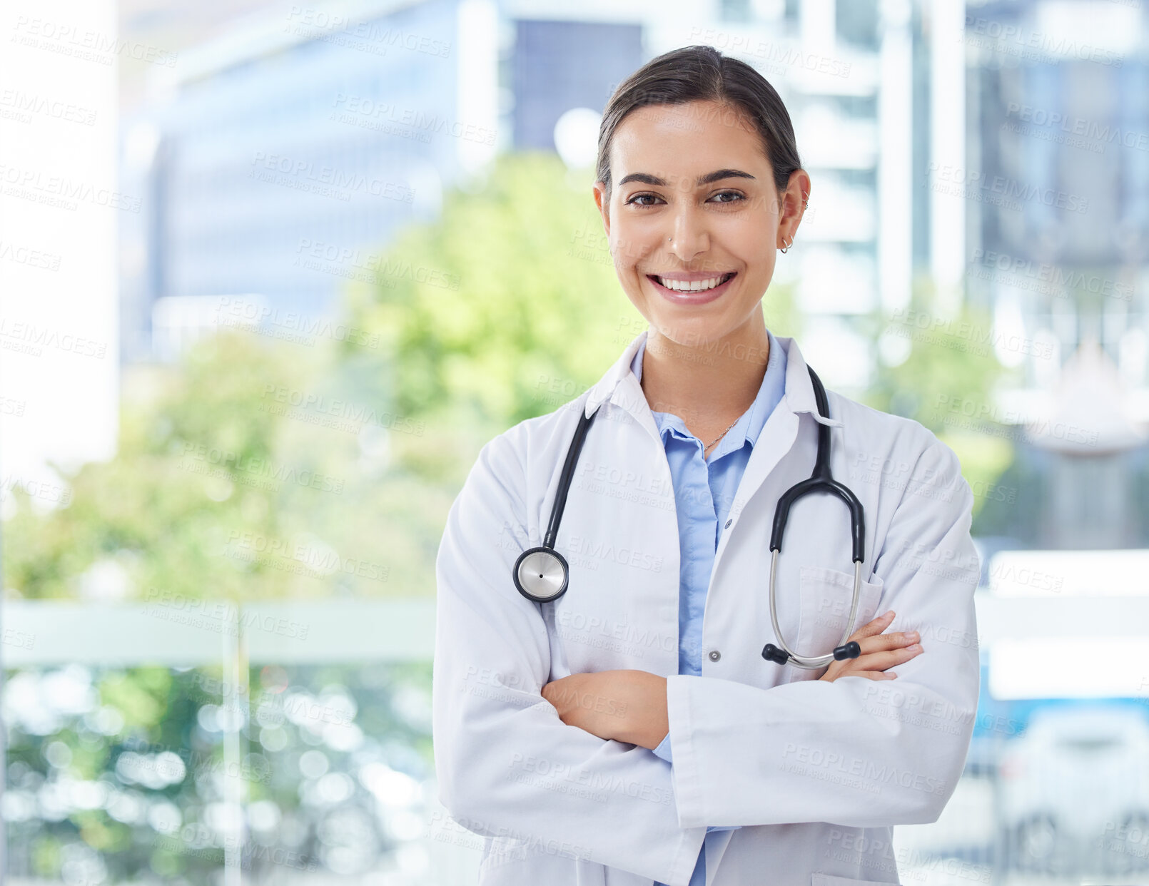 Buy stock photo Healthcare, doctor or nurse woman with stethoscope in hospital, bokeh and happy with smile. Health, trust and mission professional medical expert or worker with wellness motivation and vision