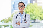 Healthcare, proud and doctor woman portrait with stethoscope in a hospital with bokeh and lens flare. Care, trust and mission of a young medical professional expert or worker with wellness motivation