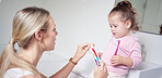 Baby kid brushing teeth with mom in bathroom, morning oral hygiene and clean dental healthcare wellness. Parent with toothpaste and toothbrush teaching young toddler girl child healthy mouth cleaning