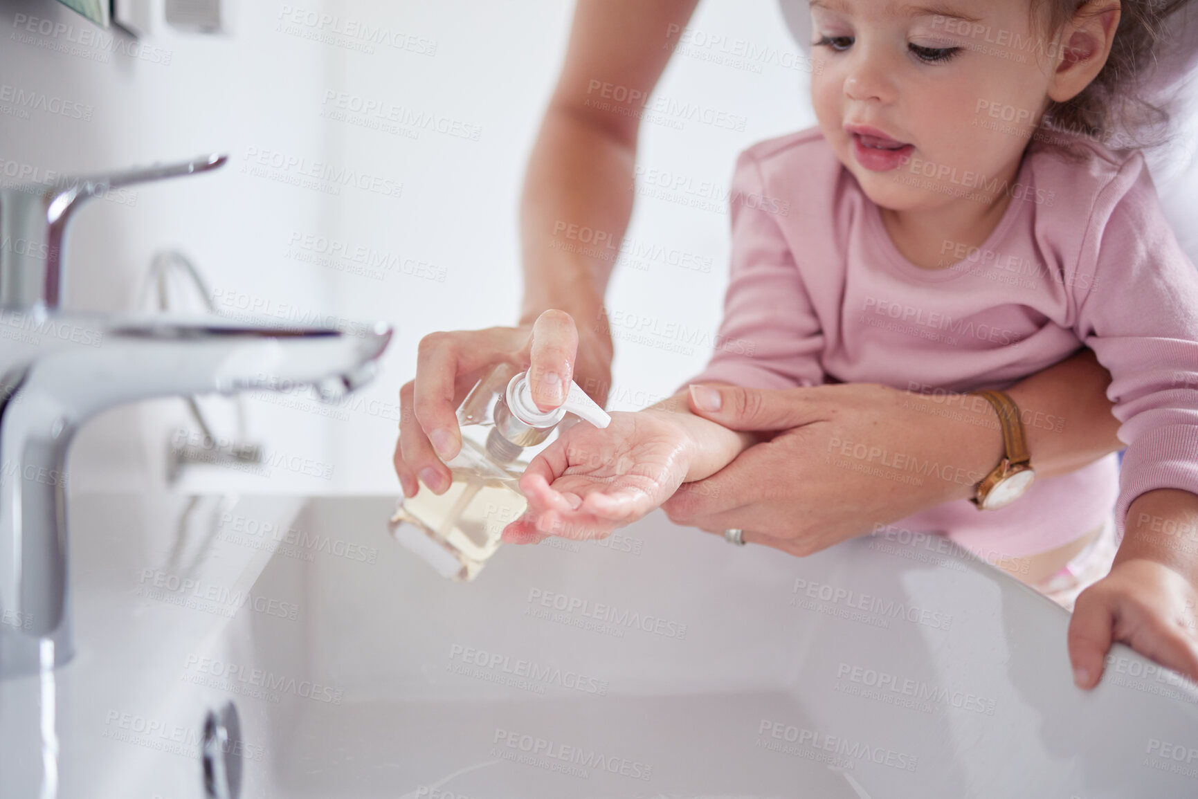 Buy stock photo Mother cleaning kids hands with sanitizer liquid soap after baby toddler had dirty fingers in the sink. Healthy, grooming and mom cleaning and helping a young girl with hygiene wellness at home