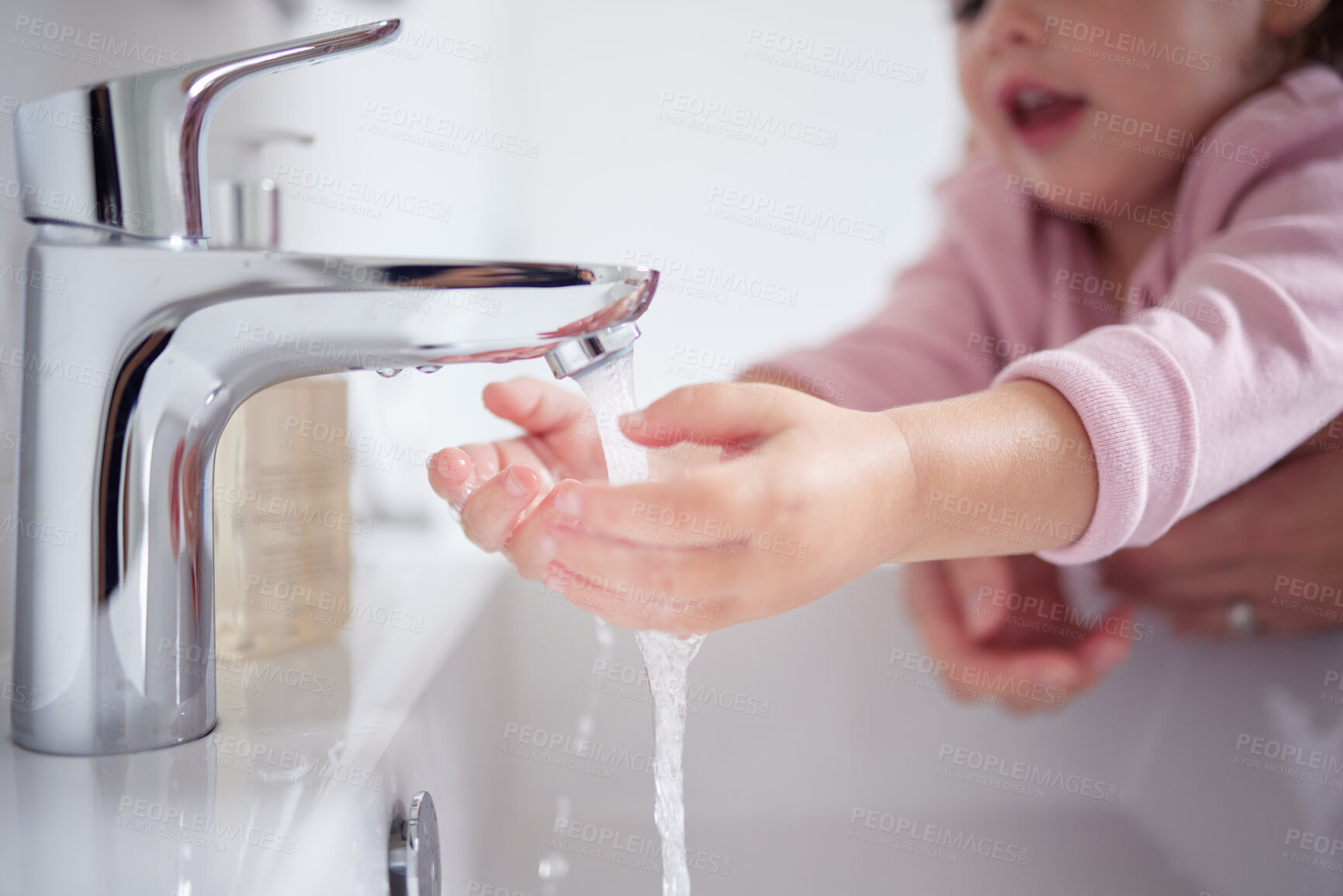 Buy stock photo Hand, water and cleaning with a girl and her mother washing her hands under a tap for hygiene and sanitation during covid in their home. Children, health and grooming in the bathroom of a house