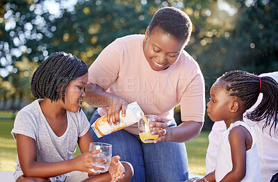 Buy stock photo Black woman, park and children family drinks juice for healthy nutrition or wellness nutritionist diet on picnic. Mother with girl kids or black people smile with citrus fruit orange juice in summer