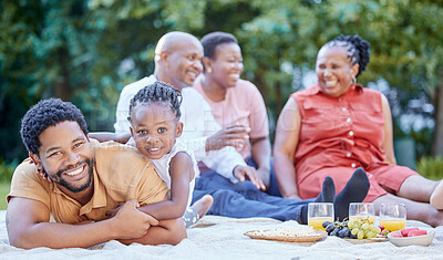 Buy stock photo Portrait of a black father and child at a picnic with family in an outdoor green garden during spring. Smile, happy and african people eating healthy fruit at a outside celebration in a park.