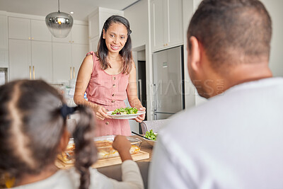 Buy stock photo Healthy, vegan mother and family with a salad for lunch, meal or eating together at the kitchen table at home. Mom, dad and child with homemade food, green vegetable snack for wellness lifestyle