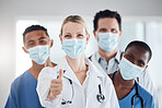 Thumbs up, mask and team of doctors and nurses at a hospital or clinic. Portrait, like gesture or approval hands after successful surgery, okay for success or welcome to the team and thank you.

