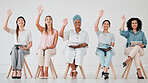Diversity, team and row sitting with hands up for question, answer or idea at the office, seminar or meeting. Happy creative business people waving hand together in corporate networking or interview