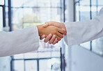 Doctors meeting, shake hands and partner at hospital with lab coats. Scientist or doctor agree on medical business, support and cooperate together with handshake. Healthcare workers in lab or clinic 