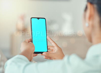 Buy stock photo Mockup, marketing and advertising on a phone with a blue screen in the hands of a woman in her home. Product placement, logo and brand on a mobile display for a creative website or homepage design