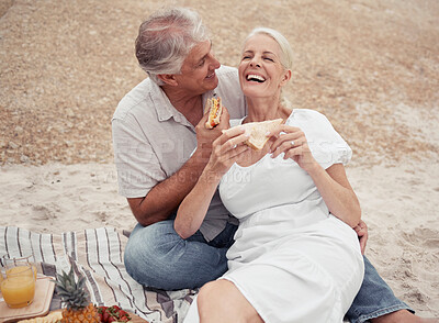 Buy stock photo Love and healthy senior couple on picnic at a beach eating sandwich with funny conversation for wellness, healthcare or retirement. Outdoor elderly woman and man with cheese bread together on ground