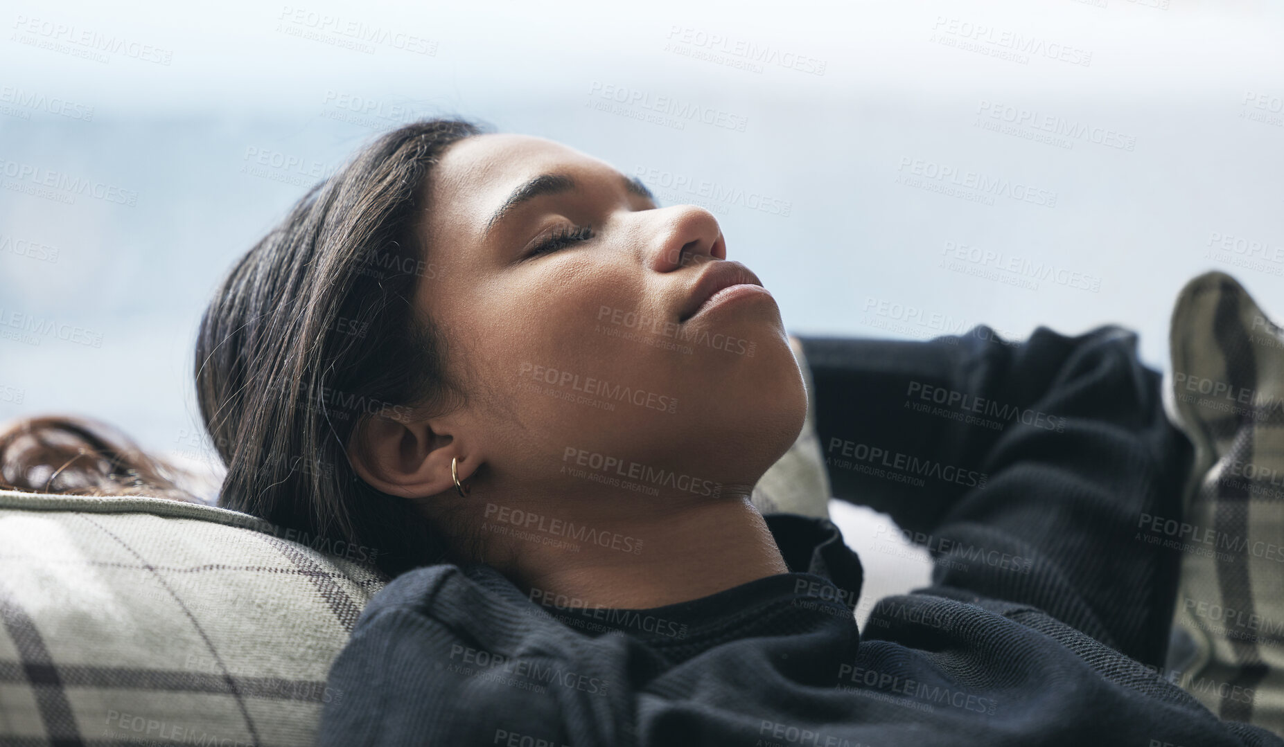 Buy stock photo Relax, tired and rest with woman on sofa in living room for stress management, mental health and fatigue. Exhausted, sleeping and peace with young female lying on couch for calm, relaxation and nap