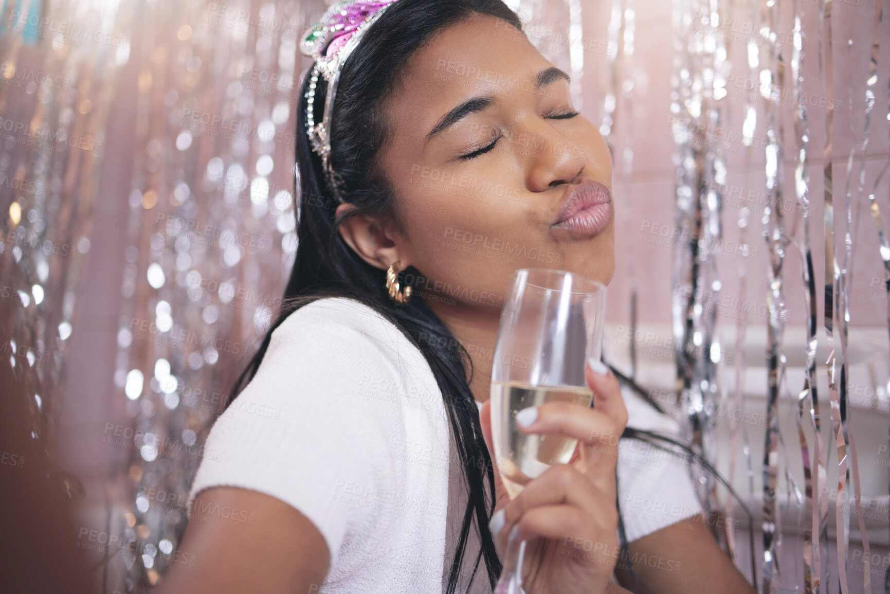 Buy stock photo Girl take selfie with glass of champagne at party, event or festival. Black woman has sparkling wine in hand at birthday celebration, comic pose against interior decoration and lighting background