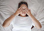 Stress, anxiety and black woman using hands over eyes to calm, relax and peace in bed. Stress management, mental health and insomnia with sleepless young female lying in bedroom for depression