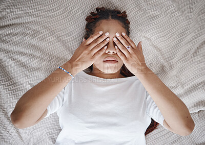 Buy stock photo Stress, anxiety and black woman using hands over eyes to calm, relax and peace in bed. Stress management, mental health and insomnia with sleepless young female lying in bedroom for depression