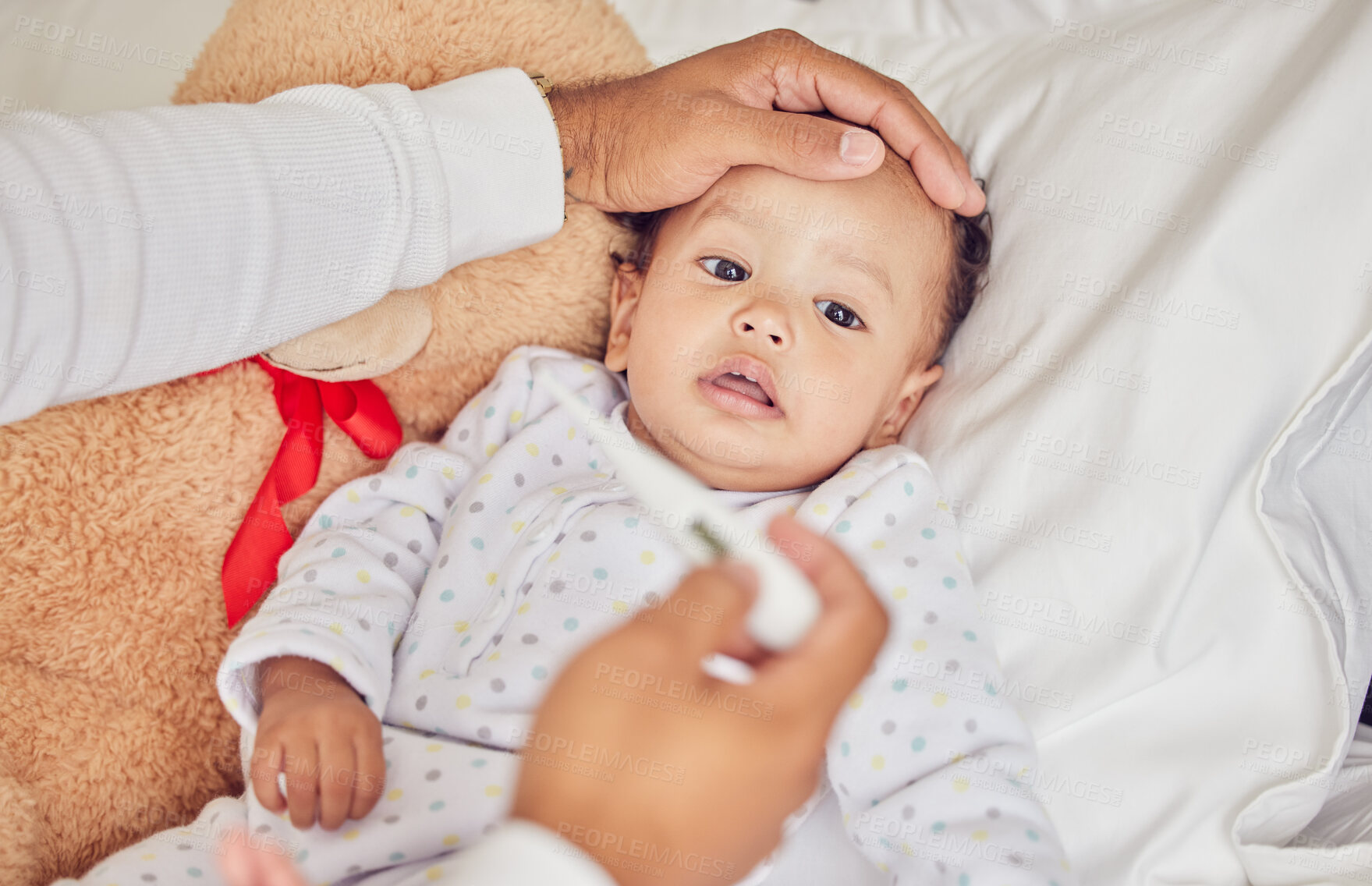 Buy stock photo Baby, sick with covid and fever with a thermometer from a parent of an unwell kid in bed of the bedroom of their home. Hand, forehead and healthcare with a child feeling unwell and resting in a house