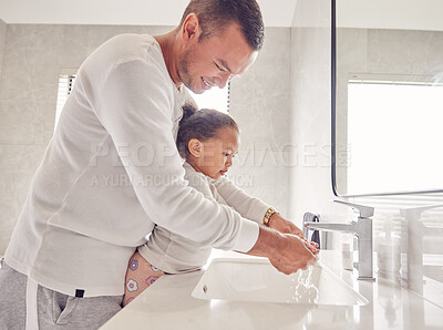 Buy stock photo Children, cleaning and family with a man and girl washing their hands in the bathroom at home together. Kids, water and hygiene with a father teaching his daughter about clean and healthy living