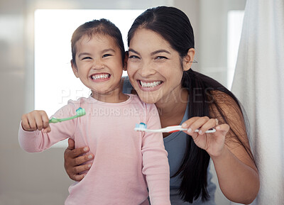 Buy stock photo Portrait of mom and kid brushing teeth, dental healthy and cleaning in bathroom at home. Happy mother and girl learning oral healthcare, wellness and fresh breath for toothbrush, toothpaste and smile
