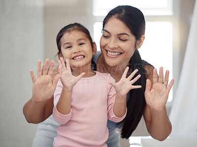 Buy stock photo Cleaning, hand and washing with mother and daughter bonding in a bathroom at home, smiling and relaxing together. Hygiene, protection and portrait of a girl feeling happy after learning healthy habit