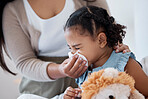 Mother clean sick child nose with tissue, playing with toy or teddy bear in bedroom at family home. Teacher at kindergarten use toilet paper, to help clean young girl face after sneeze or runny nose