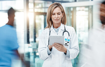 Buy stock photo Woman doctor, digital tablet planning and healthcare working in busy hospital on medical research, online test results and technology. Mature, focus and expert telehealth surgeon connect clinic app