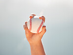 Baseball, athlete hands and ball sports while showing grip of pitcher against a clear blue sky. Exercise, game and softball with a professional player ready to throw or pitch during a match outside