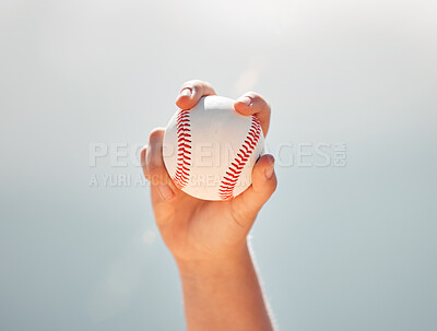 Baseball, athlete hands and ball sports while showing grip of pitcher against a clear blue sky. Exercise, game and softball with a professional player ready to throw or pitch during a match outside