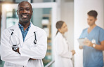 Doctor, healthcare and medicine with a man surgeon standing arms crossed in the hospital with his team in the background. Trust, insurance and care with a male health professional working in a clinic