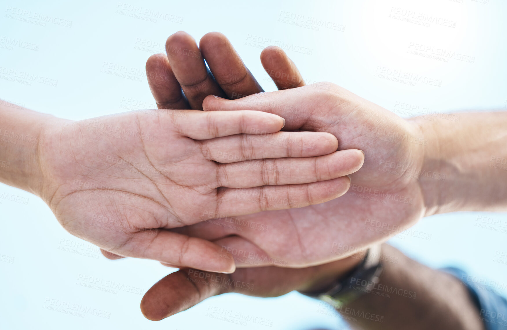 Buy stock photo Teamwork, motivation and diversity with people hands stacked with blue sky, lens flare background and mock up. Group support, community or workers standing together for goal, trust and collaboration