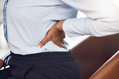 Buy stock photo Business woman with back pain from stress in the office while sitting at a corporate company. Closeup of the hand of a black professional employee holding a medical muscle injury, backache or sprain.