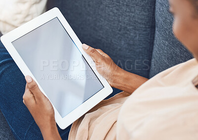 Buy stock photo Mockup digital tablet, in hands of black woman on couch in a living room in her house and goes online to find entertainment. Mobile technology is used for social media, e-commerce and video call 