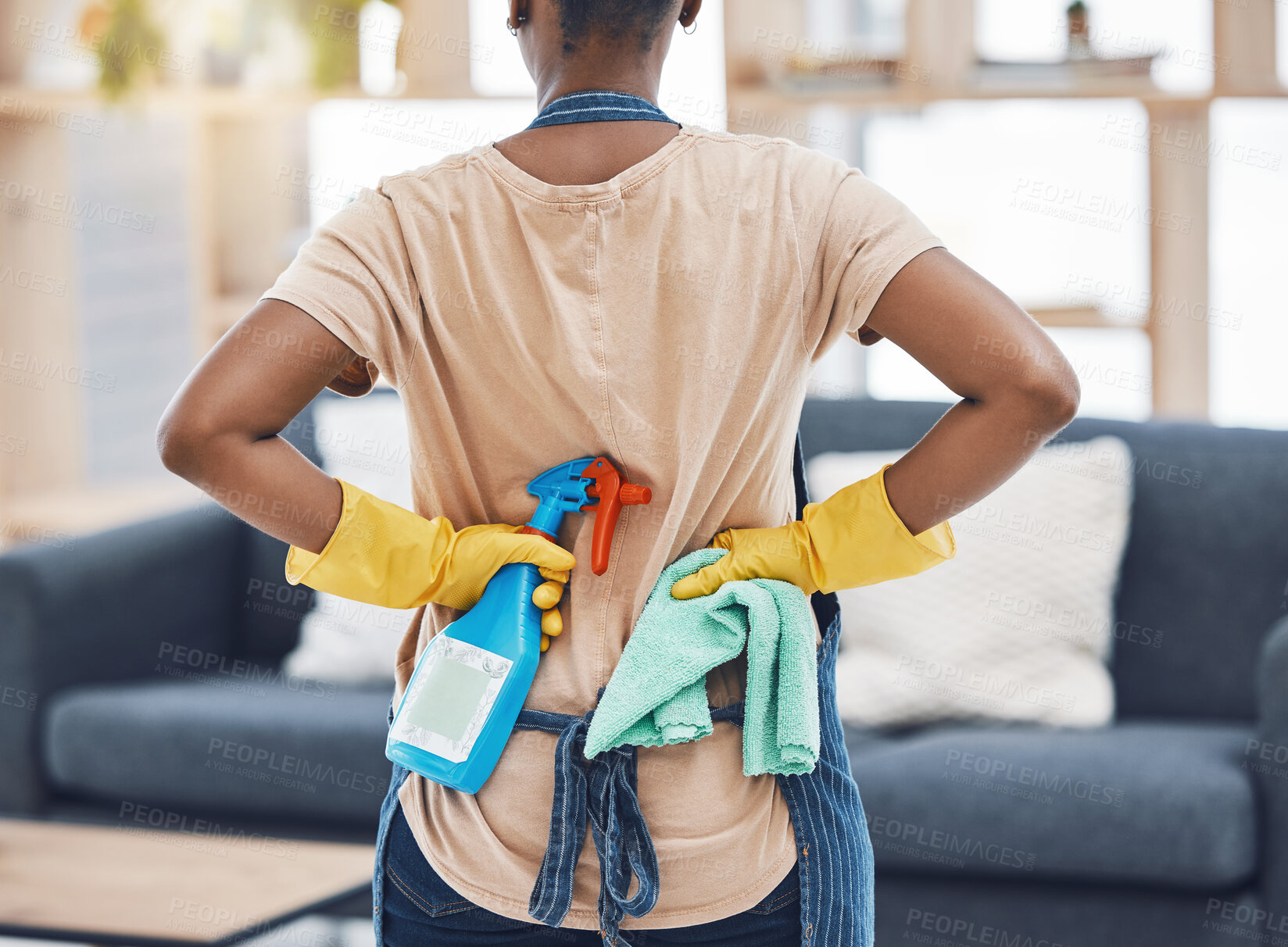 Buy stock photo Black woman, spring cleaning and ready with bottle spray, cloth and gloves for hygiene, fresh home and lounge. Back of female cleaner service, maid and housekeeper disinfect in routine household task