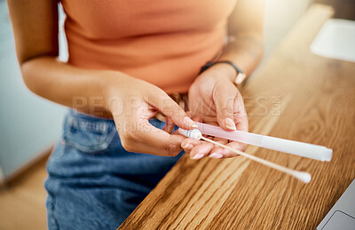 Buy stock photo Woman with kit for covid test in hand at desk, to analyse results and get diagnosis for wellness in home. Woman with cotton swab and tube at table, do PCR test for symptoms or sign of coronavirus