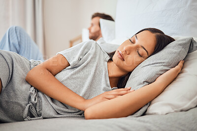 Buy stock photo Sleeping, peace and woman asleep on bed with comfortable pillow while taking nap to relax with sleepless partner in background. Couple, sexual problems and carefree wife lying eyes closed next to man