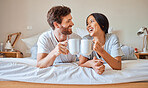 Happy morning, coffee and couple smile in bed feeling relax, love and happiness in a bedroom home. Smiling boyfriend and girlfriend together in a house laughing and spending quality time drinking tea