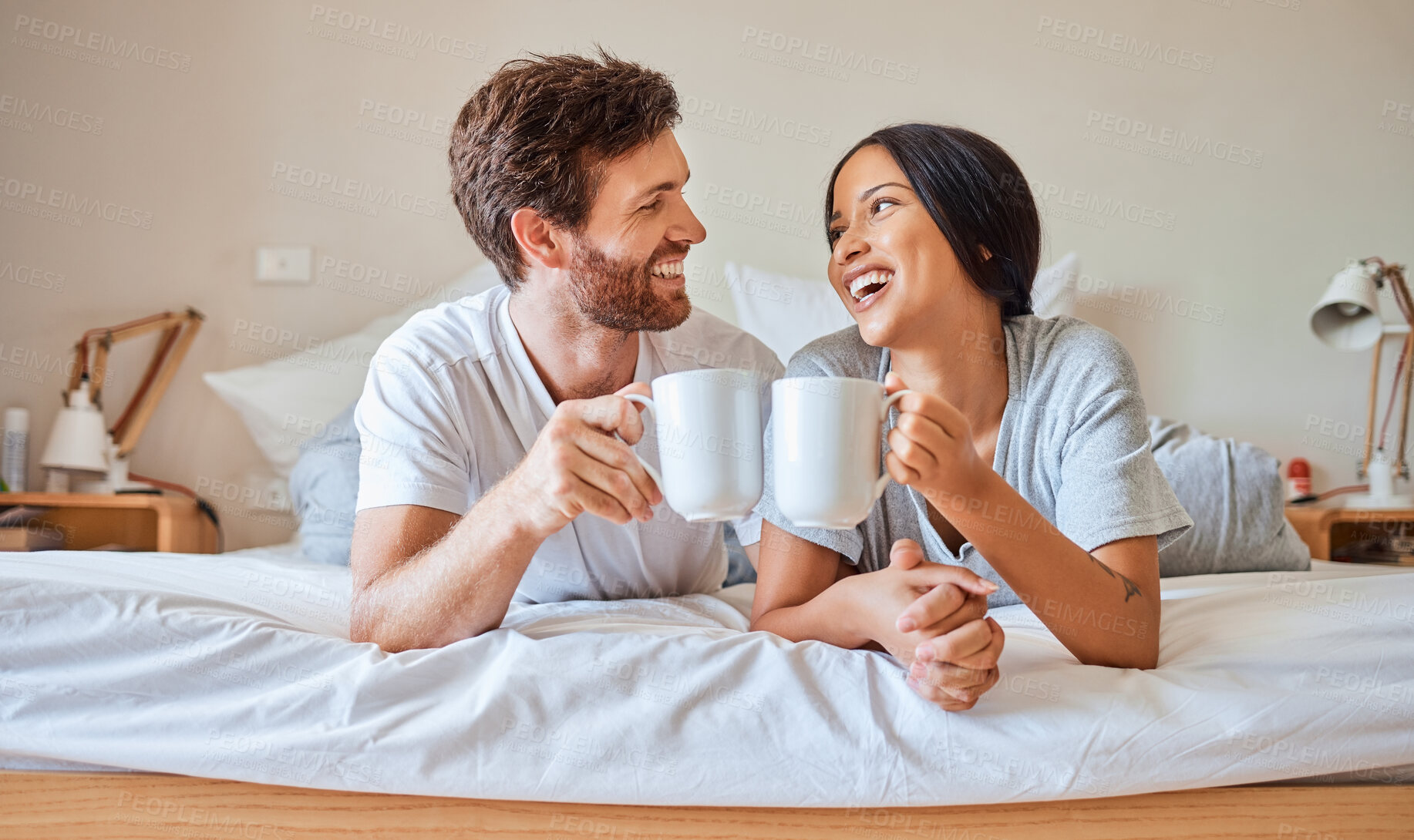 Buy stock photo Happy morning, coffee and couple smile in bed feeling relax, love and happiness in a bedroom home. Smiling boyfriend and girlfriend together in a house laughing and spending quality time drinking tea