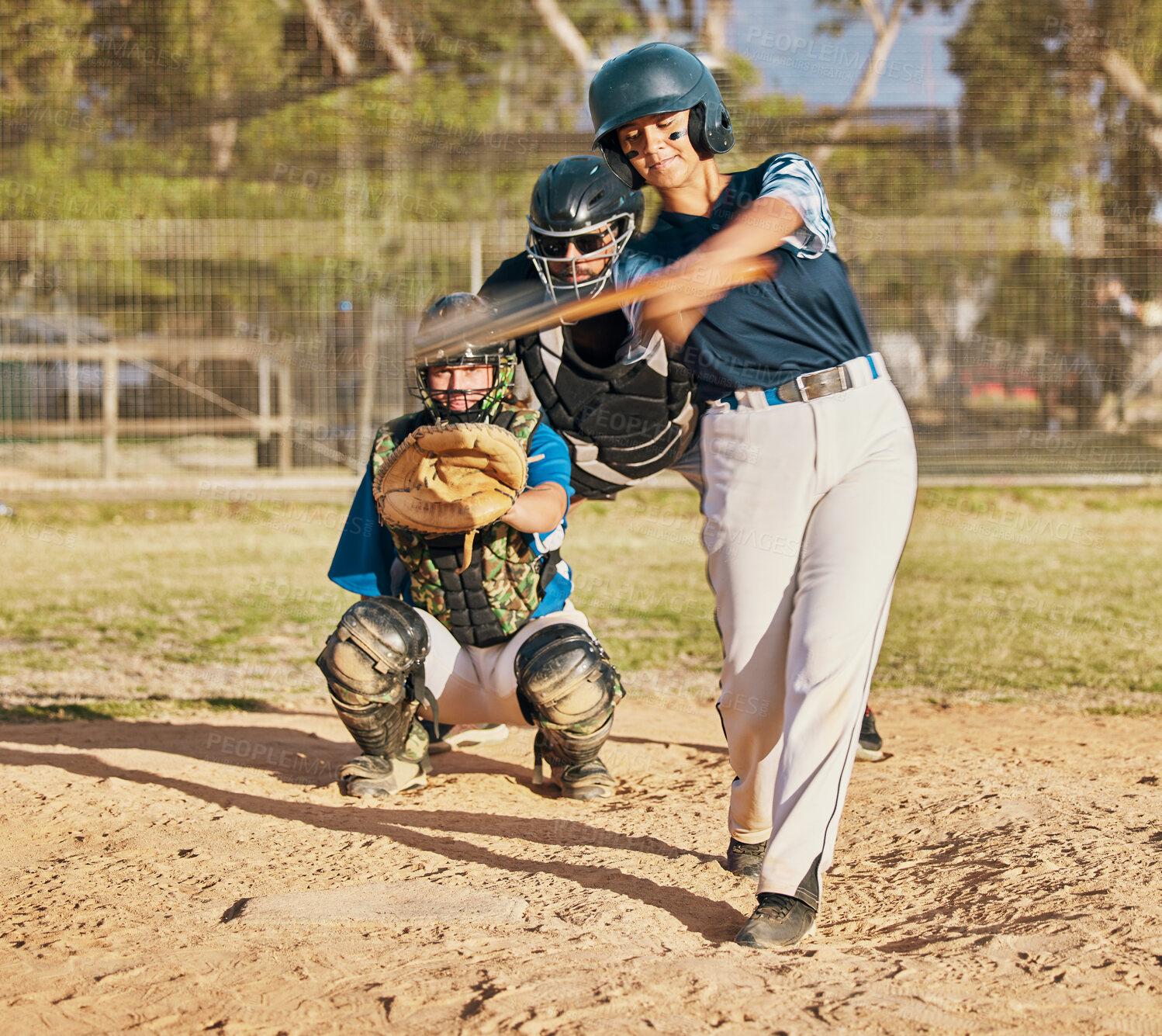 Buy stock photo Baseball player, female athlete and swinging bat with sports technique or skill while playing a competitive game or match on a pitch or field. Fit female with a catcher doing exercise and recreation 