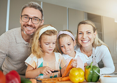 Buy stock photo Mom, dad and children in the kitchen, cooking together and learning. Portrait of family at home teaching kids how to cook, cut vegetables and prepare food. Child development, educate and life skills