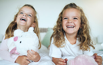 Buy stock photo Children, teddy bear and happy sisters playing together in their bedroom at their family home. Happiness, smile and bond between twin siblings holding a toy while relaxing on a bed in their room.