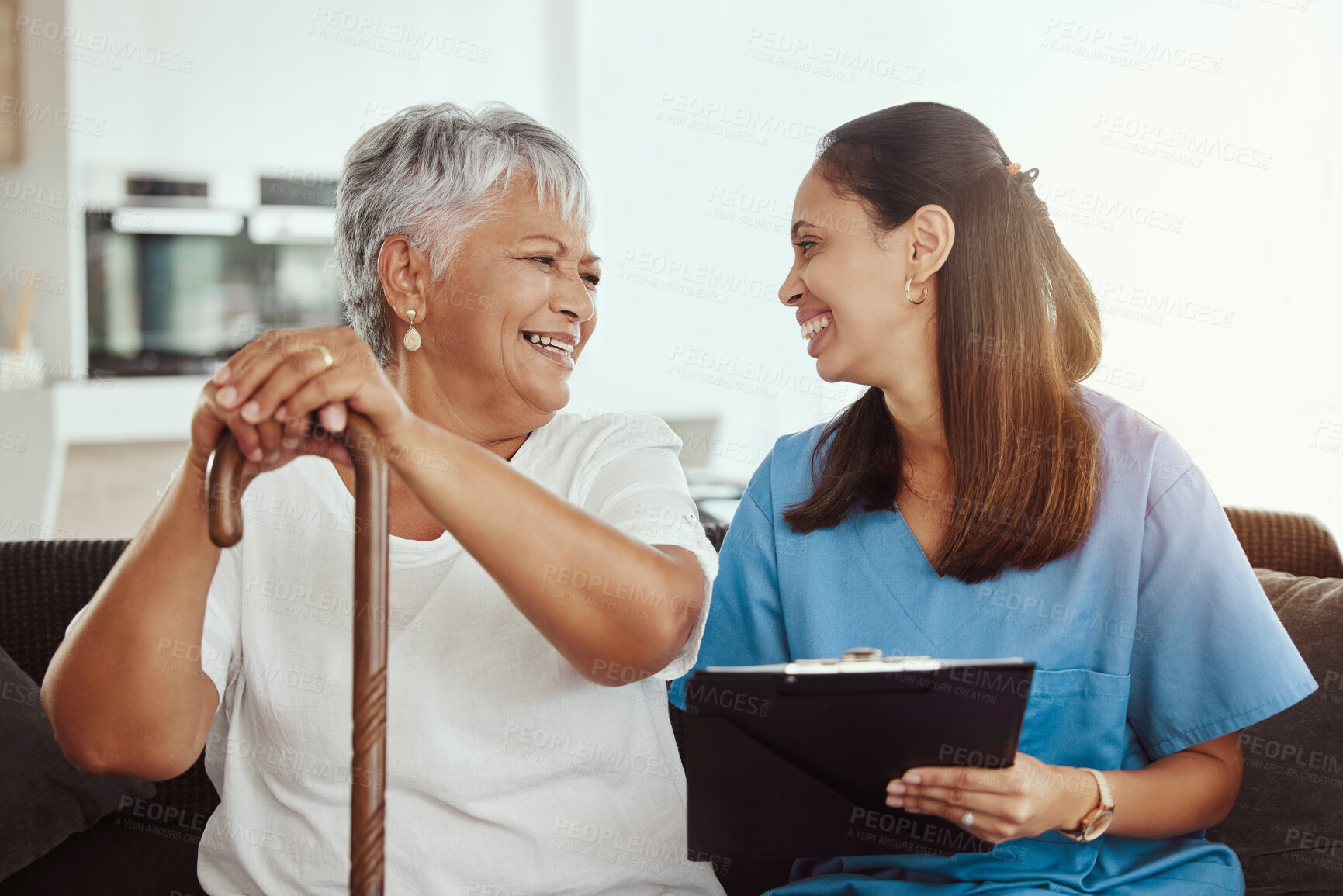 Buy stock photo Senior care, healthcare insurance and caregiver woman sitting with elderly woman patient laughing and talking while enjoying retirement home. Old lady and female nurse hospice with health check form