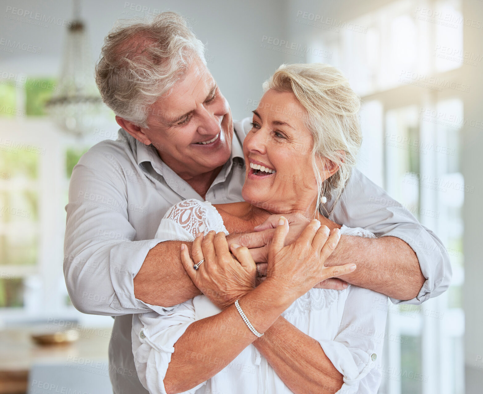Buy stock photo Senior couple, happy and hug for love, support and care in relationship at home embrace, bond or smile. Romance, married or retired old elderly man and woman in retirement celebrate marriage together