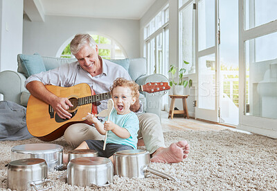 Buy stock photo Child drummer with grandfather, guitar and music playing with pot drums in the living room at house. Happy, excited and smile of boy bonding and spending time with his elderly grandpa in family home.