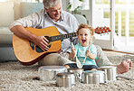 Music, pots and old man playing with baby on living room floor with drums, pans and wooden spoon instruments with his guitar. Memory, smile and senior grandparent enjoys time with a happy grandchild 