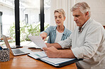 Retirement couple budget, finance and investment planning, loan and paper bills for online banking at home. Senior man, woman and people reading tax money report, cash savings and admin document note