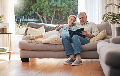 Buy stock photo Retirement senior couple with photo album book on sofa together in summer house for vacation holiday. Happy elderly woman or people relax on couch in living room reading, talking of marriage history