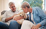 Love, relax and retirement couple with dog pet on living room sofa together in house. Senior, happy and married caucasian people enjoy bonding with an animal companion in family home.

